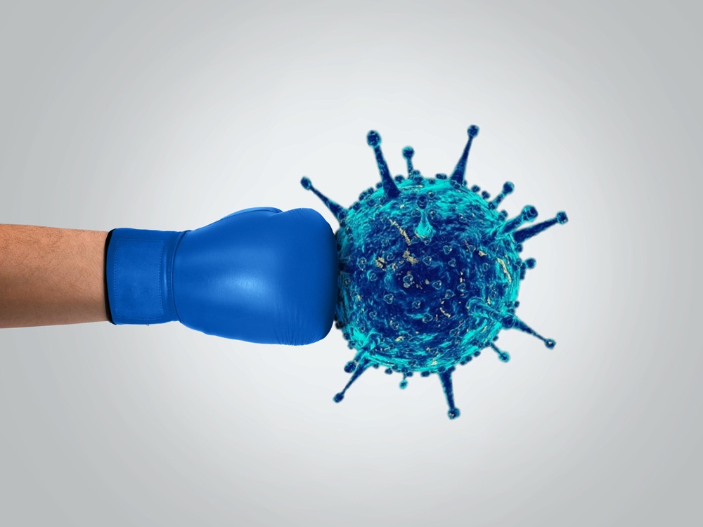 A blue boxing glove punching a virus.
