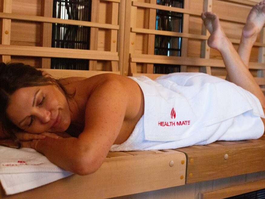 Woman relaxes and detoxes in her Health Mate Infrared Sauna