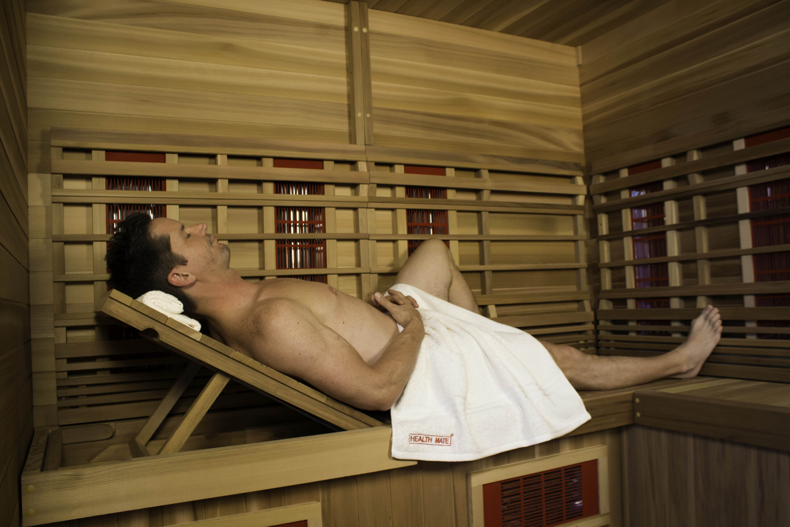 health-mate-infrared-sauna-therapy-lounge-man guy reclining in sauna