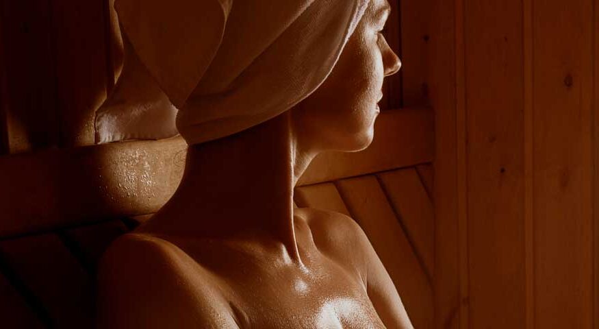 A woman relaxing and sweating in an infrared sauna.