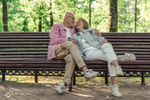 senior couple on park bench enjoying each other's company