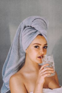 woman staying hydrated after sitting in infrared sauna