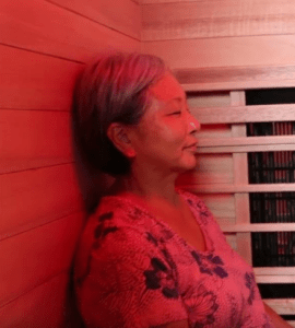 Senior woman enjoying benefits of red light in infrared sauna