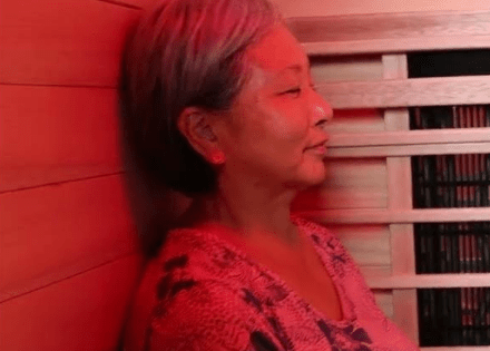 Senior woman enjoying benefits of red light in infrared sauna