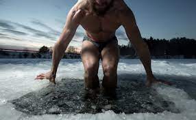man sitting in ice water